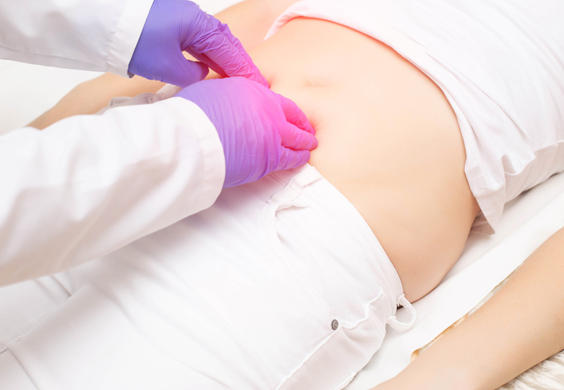 Doctor-examining-patient’s-abdomen-for-interstitial-cystitis