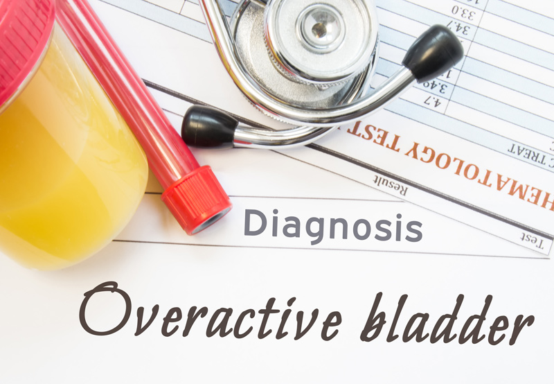 Overactive-bladder-diagnosis-with-stethoscope-and-urine-sample-cup